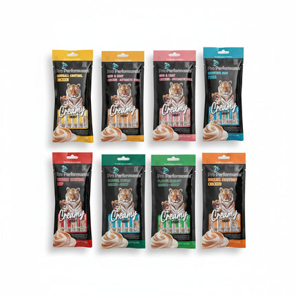 Six packages of Pro Performance cat treats with tiger branding on a textured surface.