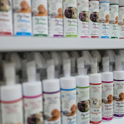 Row of pet care products on a shelf with visible branding.